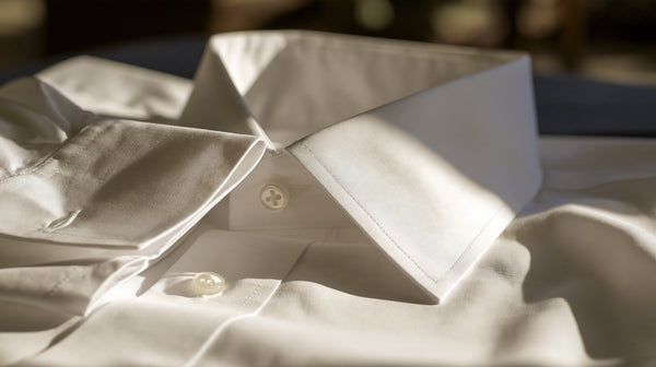 Crisp white cotton shirt collar and cuff in close detail